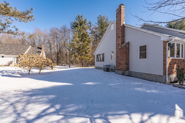 yard covered in snow with central AC