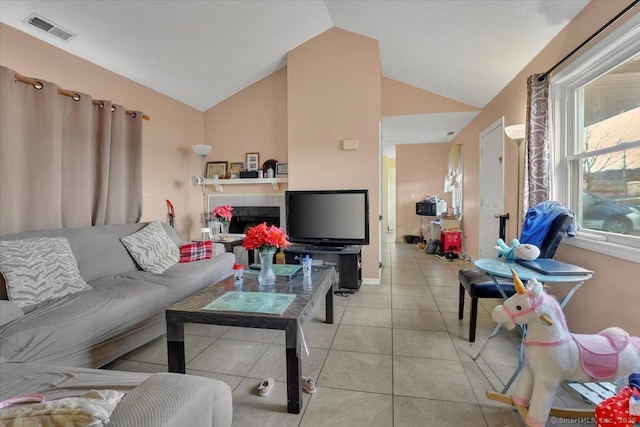 living room with vaulted ceiling and light tile patterned floors