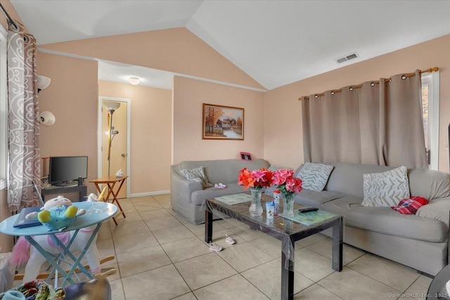 living room with light tile patterned floors and vaulted ceiling