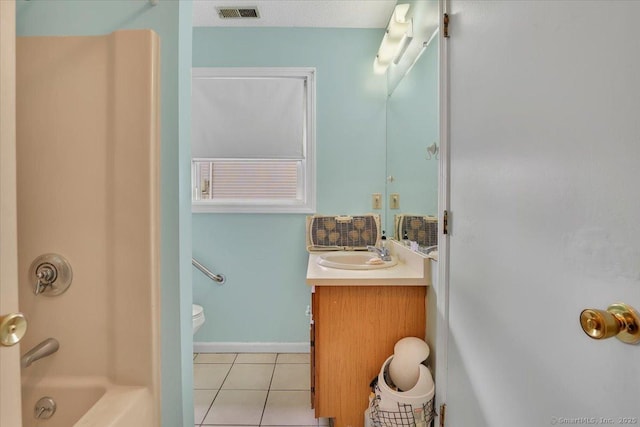 full bathroom with washtub / shower combination, tile patterned floors, toilet, and vanity