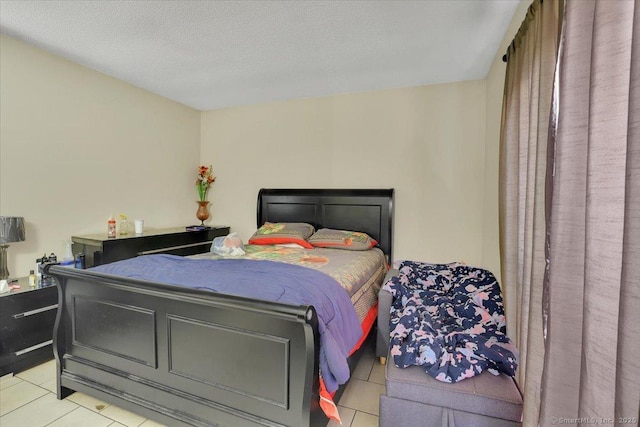 tiled bedroom with a textured ceiling