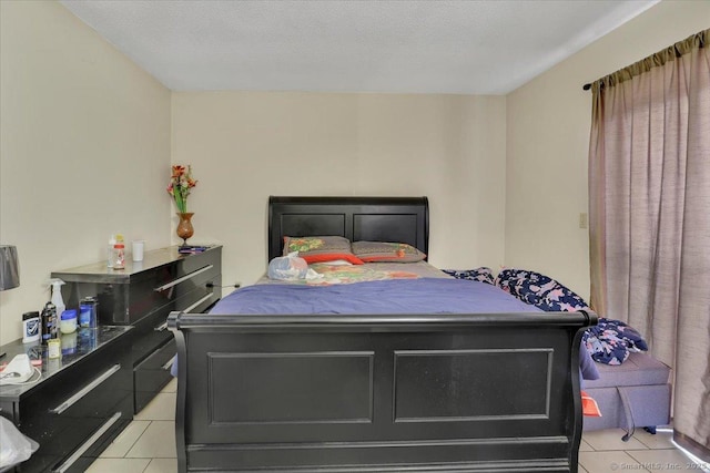 bedroom featuring light tile patterned flooring and a textured ceiling