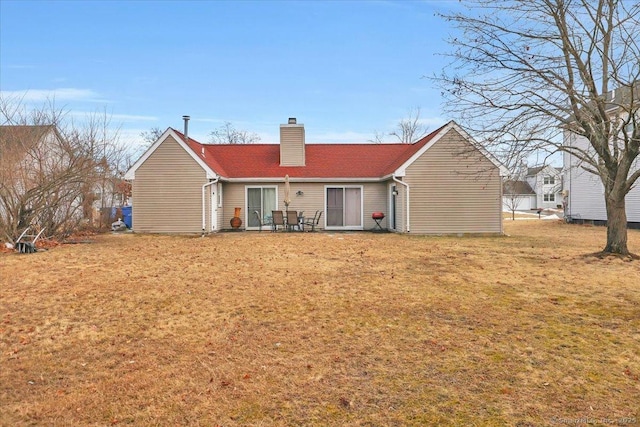 back of property featuring a lawn