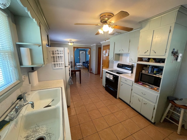 kitchen with sink, white cabinetry, light tile patterned floors, ornamental molding, and black range with electric cooktop