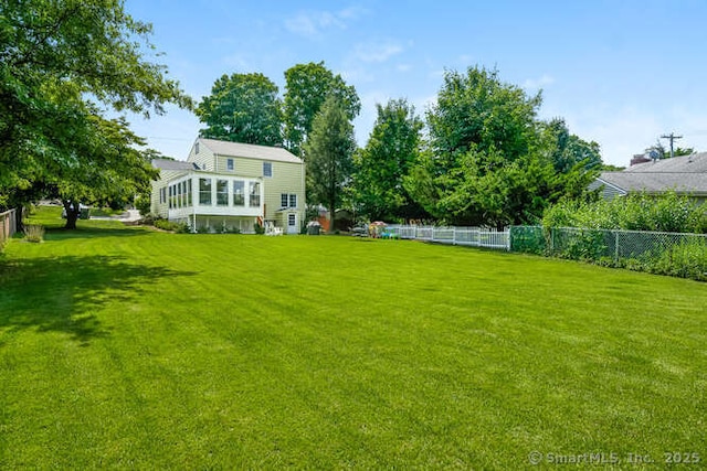 view of yard featuring a sunroom