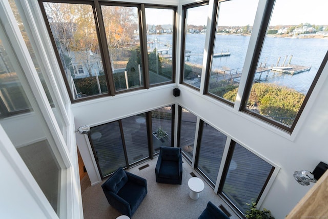 sunroom with a water view and plenty of natural light