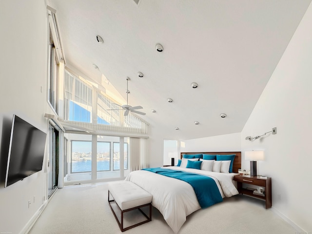 bedroom featuring a water view, light colored carpet, and high vaulted ceiling