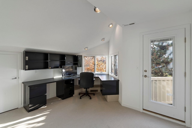 home office featuring vaulted ceiling and light colored carpet