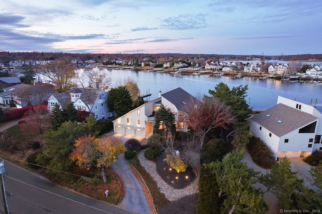 aerial view at dusk with a water view