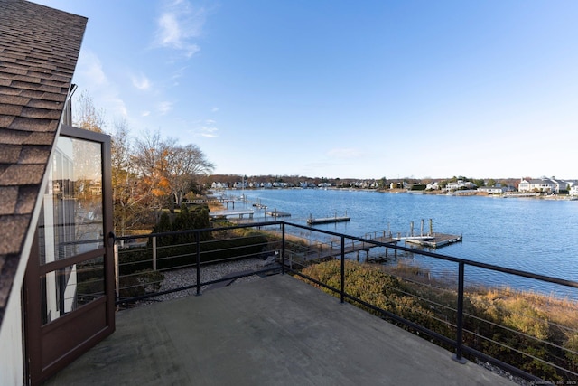 view of patio with a water view and a boat dock