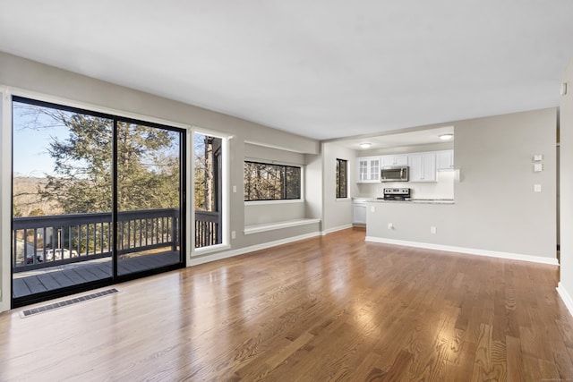 unfurnished living room with hardwood / wood-style flooring