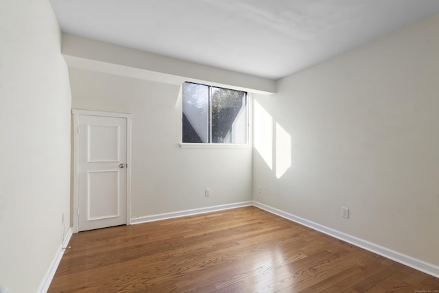 spare room featuring hardwood / wood-style floors