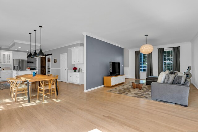 living room featuring crown molding and light hardwood / wood-style floors