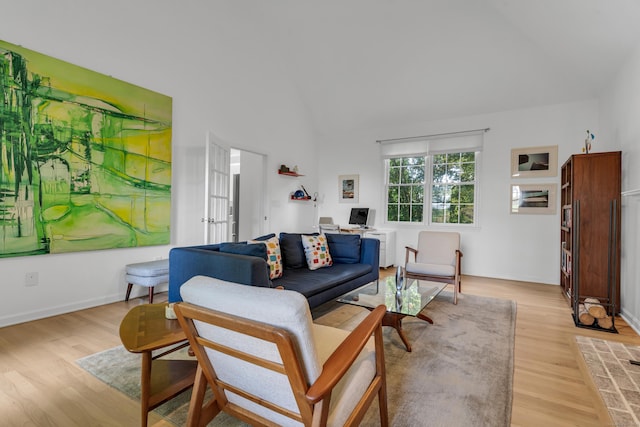 living room featuring light wood-type flooring and lofted ceiling