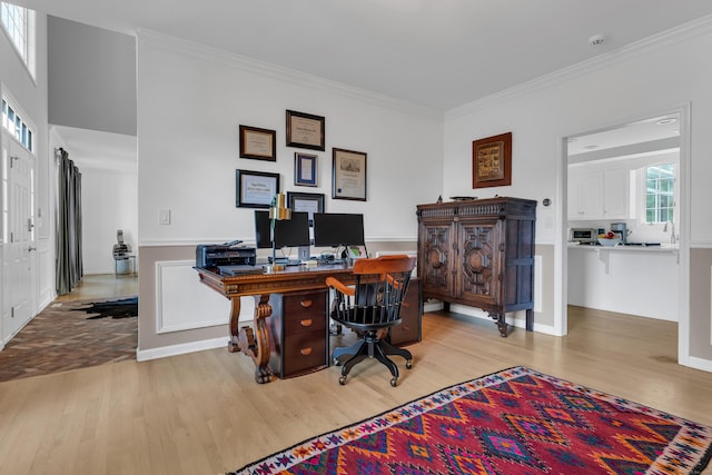 office area featuring ornamental molding and light hardwood / wood-style floors