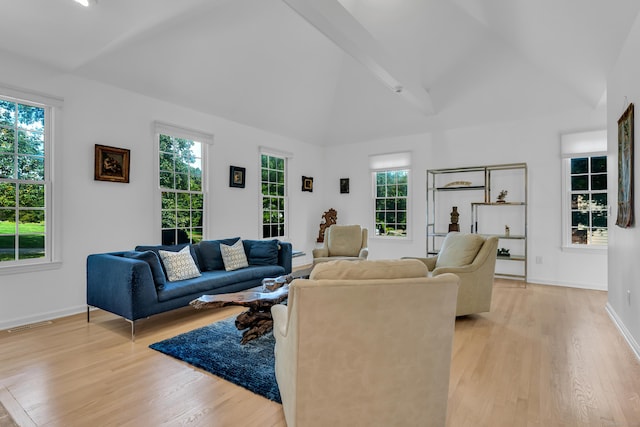 living room with baseboards, vaulted ceiling, visible vents, and light wood finished floors