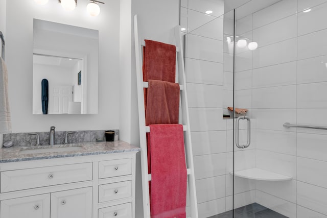 bathroom with vanity and a shower with shower door