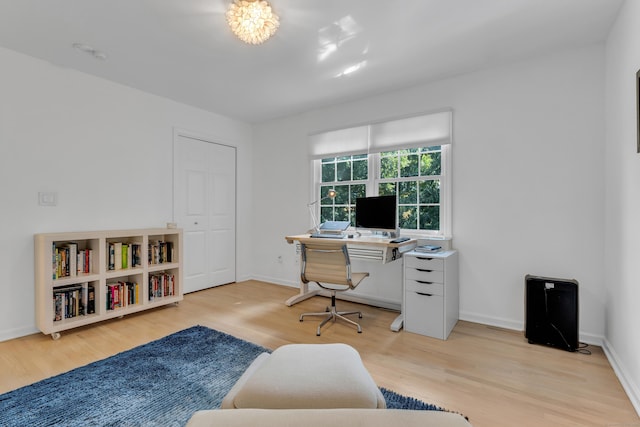 home office featuring light wood finished floors and baseboards