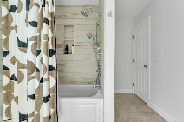 full bathroom with shower / tub combo and baseboards