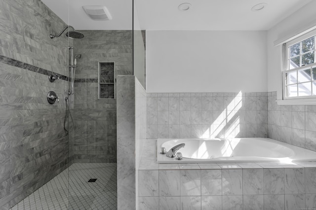 full bath with a garden tub, visible vents, and tiled shower