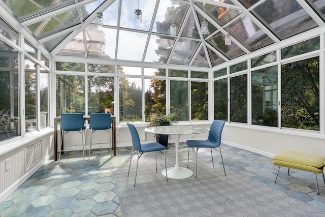 unfurnished sunroom with vaulted ceiling