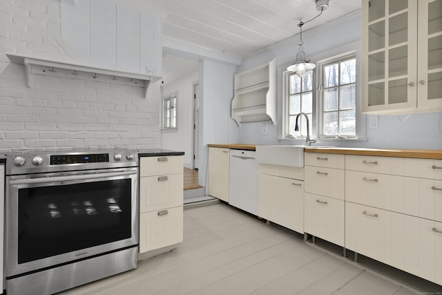 kitchen featuring white dishwasher, decorative light fixtures, stainless steel electric stove, and plenty of natural light