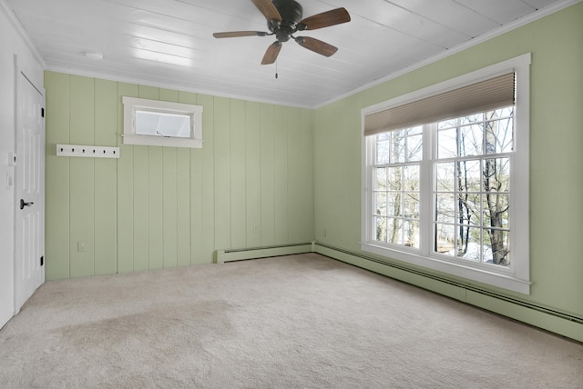 carpeted spare room with crown molding, a baseboard heating unit, and ceiling fan