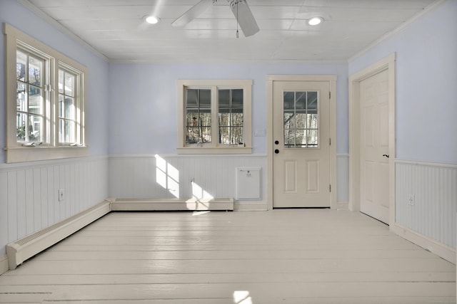 interior space featuring crown molding, a baseboard heating unit, ceiling fan, and light hardwood / wood-style flooring