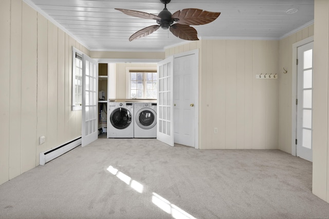 laundry area with french doors, crown molding, separate washer and dryer, baseboard heating, and light colored carpet