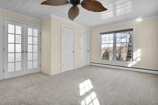 unfurnished bedroom featuring ornamental molding, light carpet, baseboard heating, and french doors