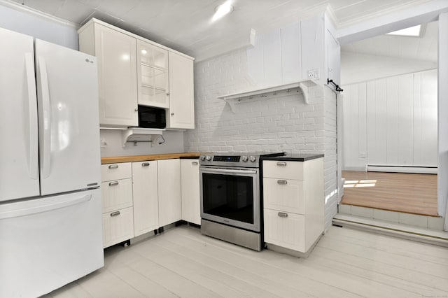 kitchen featuring white refrigerator, light hardwood / wood-style floors, stainless steel electric range, and white cabinets