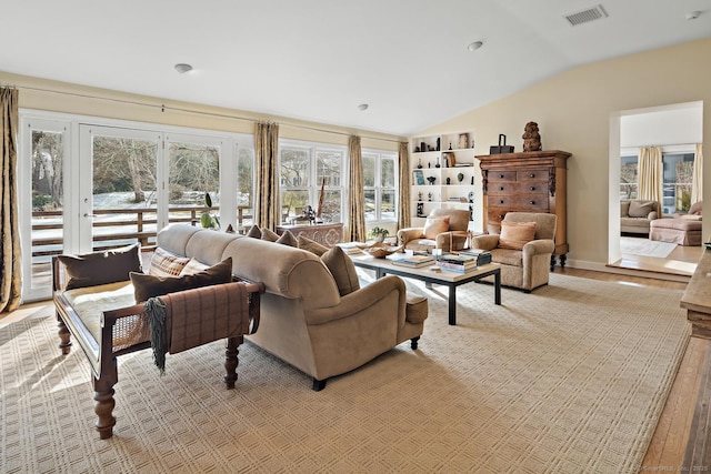 living room with lofted ceiling and light hardwood / wood-style floors