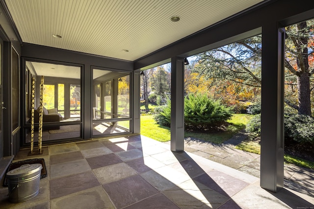 unfurnished sunroom featuring wood ceiling