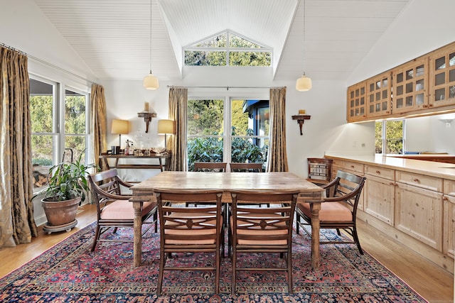 dining area with wood-type flooring and lofted ceiling