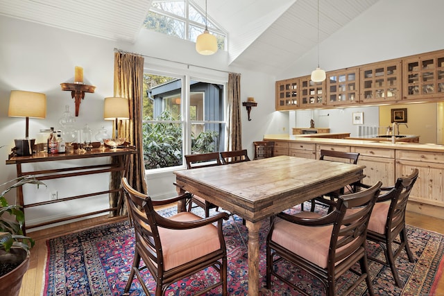 dining space featuring lofted ceiling, hardwood / wood-style flooring, and wooden ceiling