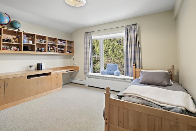 bedroom featuring lofted ceiling, built in desk, light carpet, and a baseboard heating unit