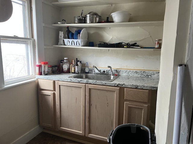 bar featuring a sink and baseboards