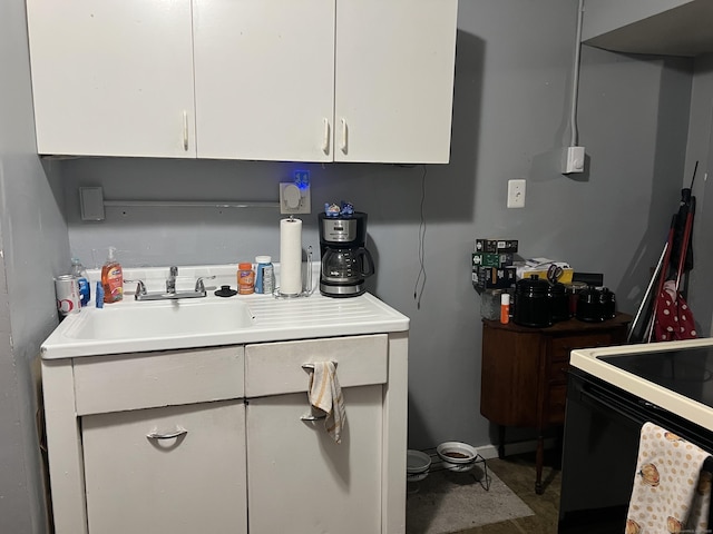 kitchen featuring light countertops, white cabinetry, and black range with electric cooktop