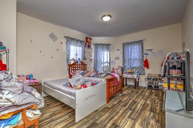 bedroom with dark wood-type flooring