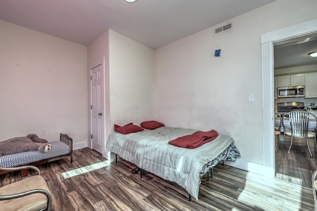 bedroom featuring dark hardwood / wood-style flooring