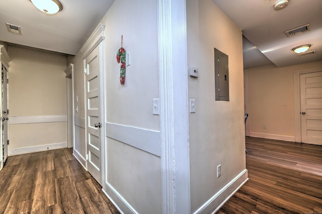 hall with dark hardwood / wood-style floors and electric panel