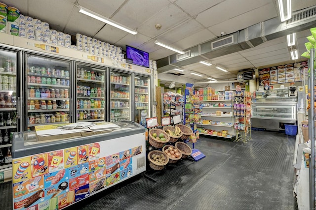 interior space with a paneled ceiling