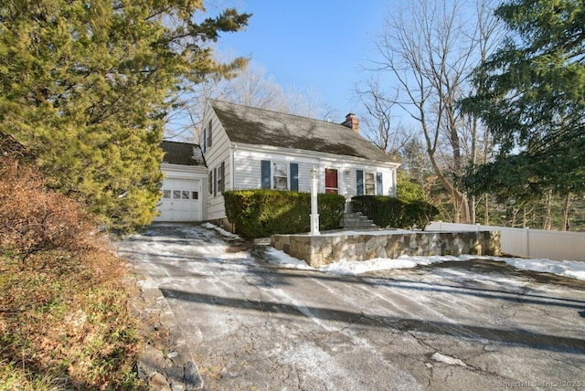 cape cod-style house with a garage