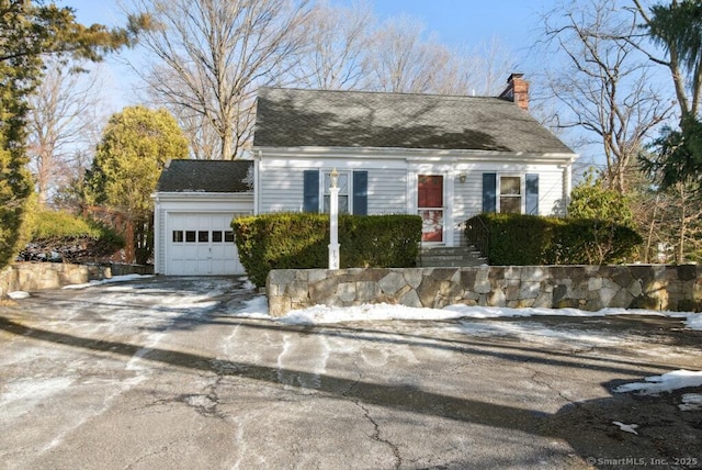 cape cod home with a garage