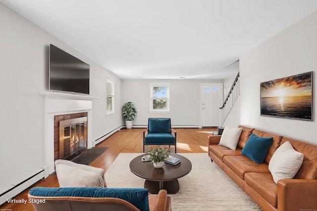 living room featuring light hardwood / wood-style flooring and a baseboard heating unit