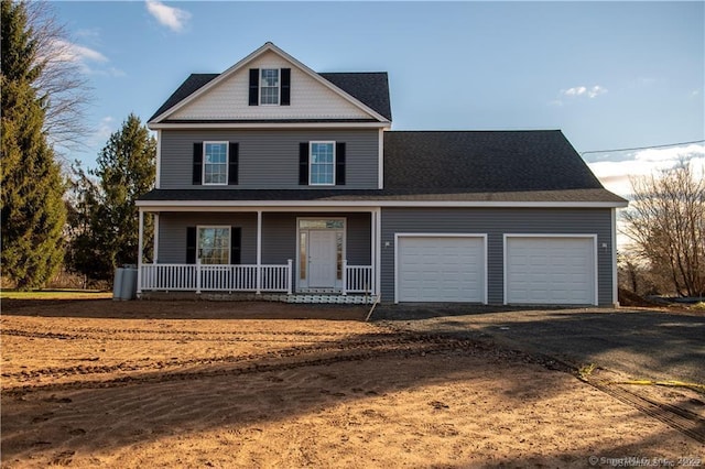 view of property featuring a garage and covered porch