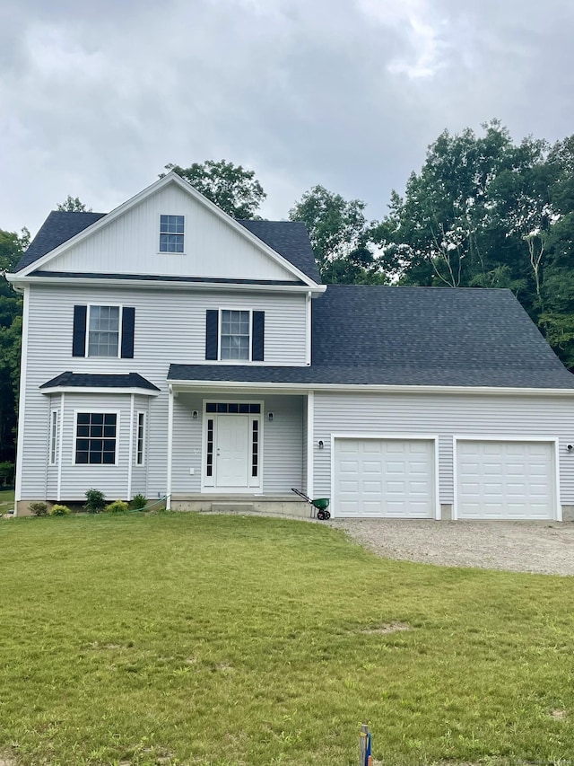 view of front property featuring a garage, a porch, and a front lawn