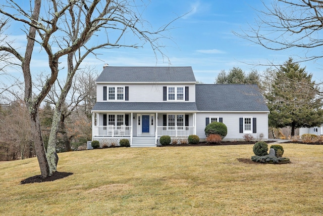 view of front of house with covered porch, a shingled roof, and a front yard