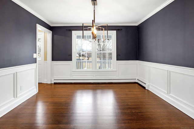 unfurnished dining area featuring a notable chandelier, dark wood-type flooring, ornamental molding, baseboard heating, and wainscoting