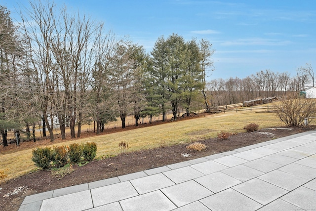 view of yard featuring fence and a rural view